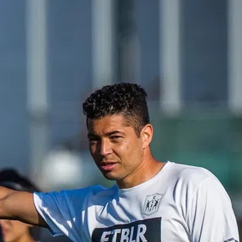 Chris Lopez coaching on a field