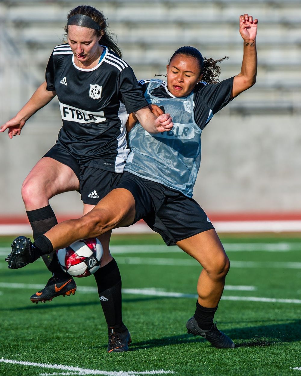 Two players competing for the ball during a session